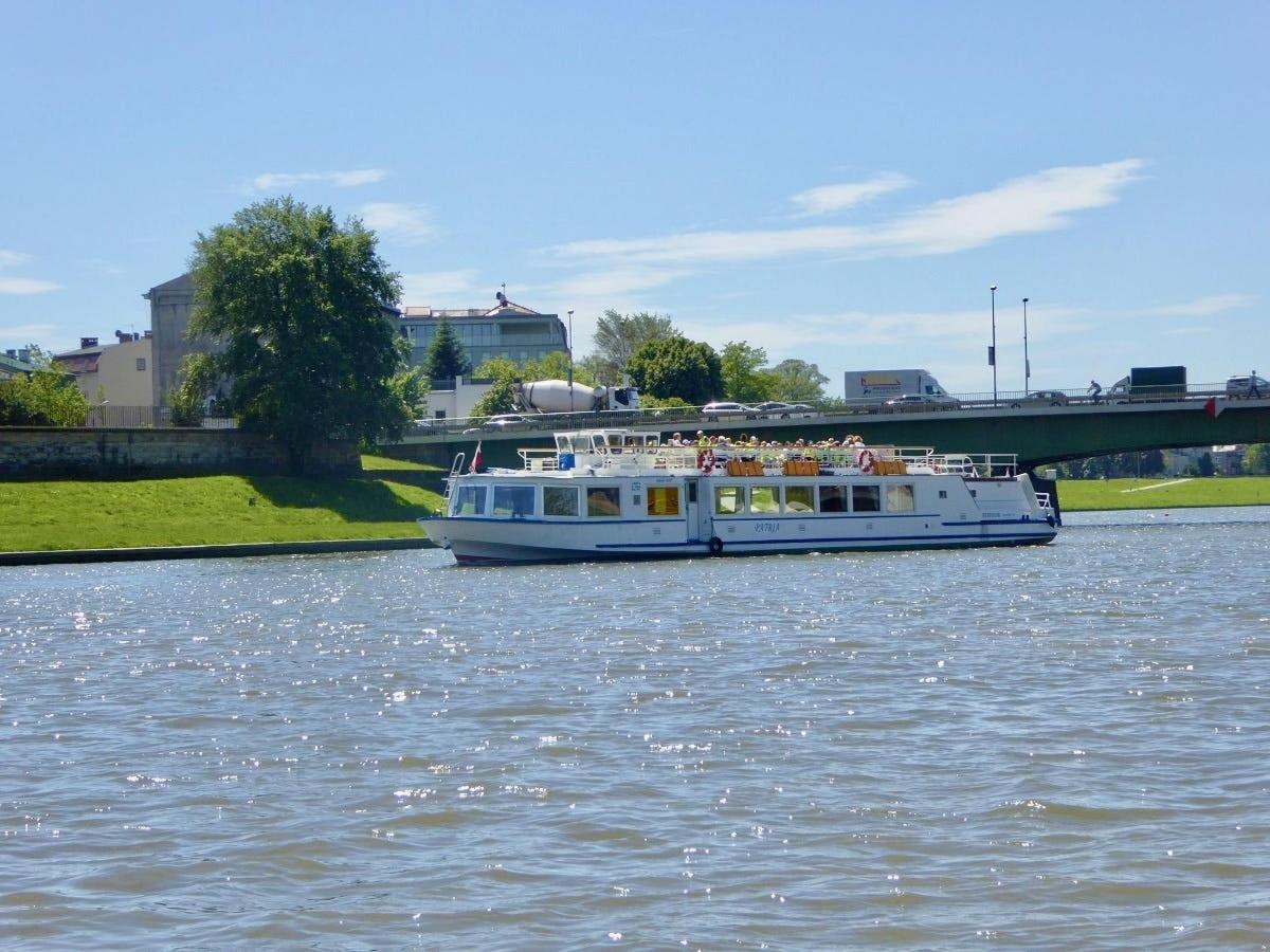 a boat on a river with a bridge in the background