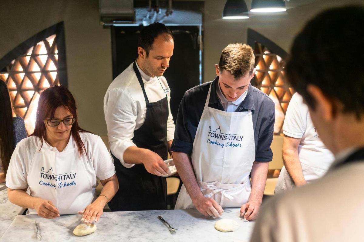 a group of people in a kitchen preparing food