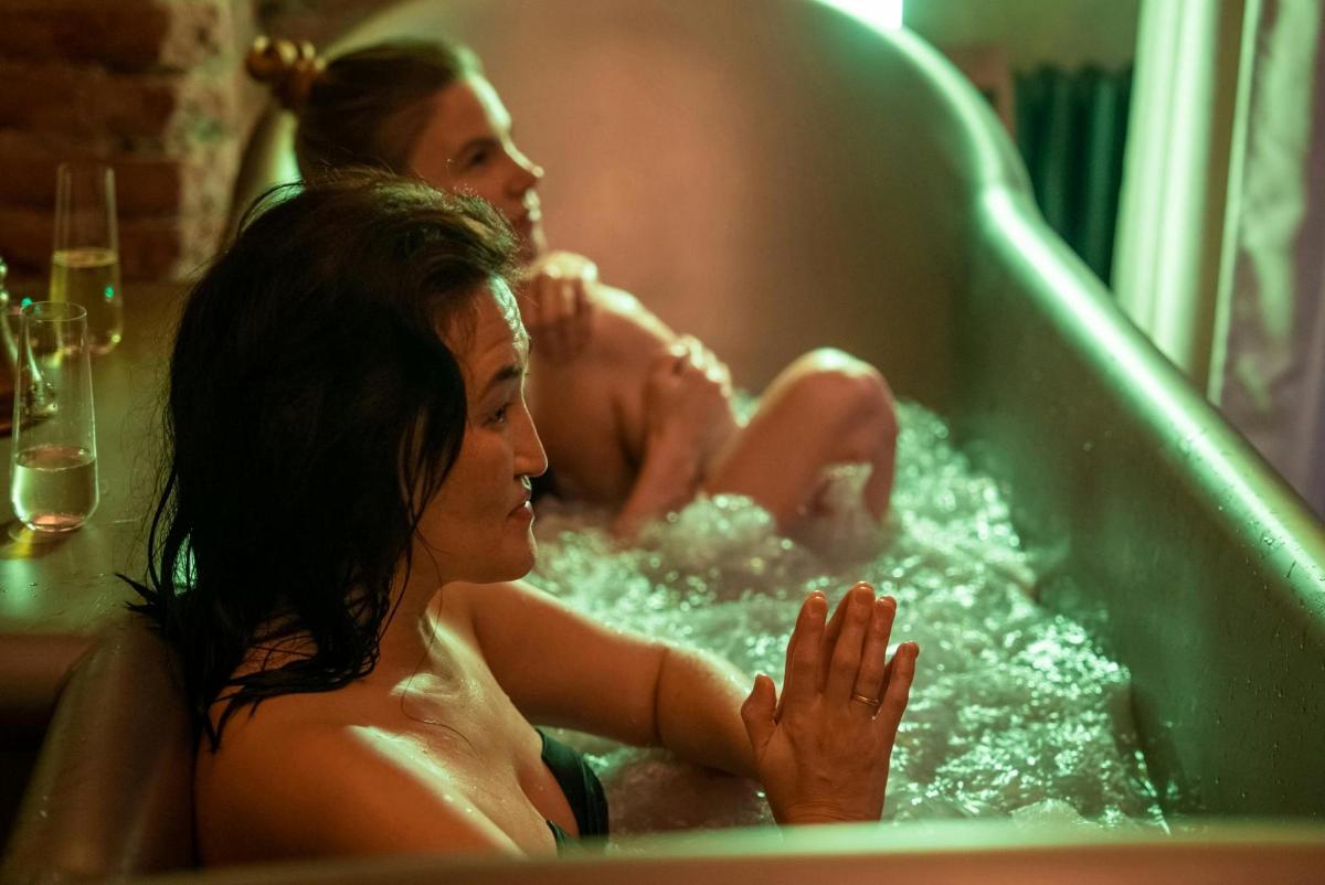 two people in a bathtub with water