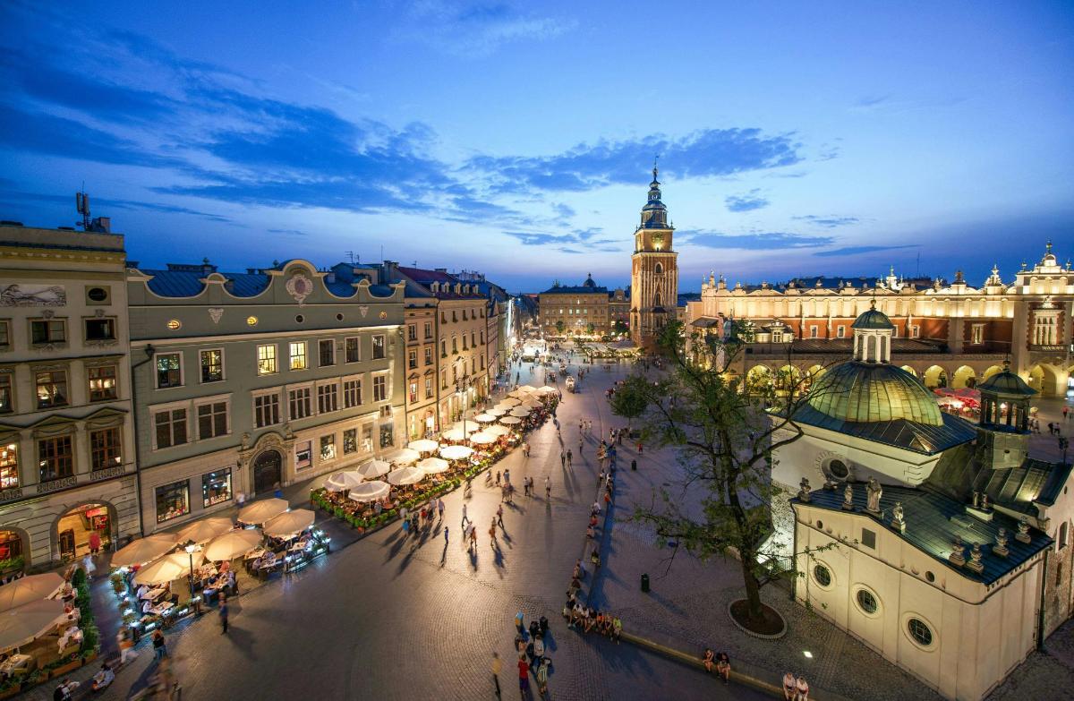 a city street at night with a clock tower