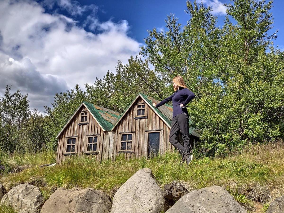 a woman is standing in front of a house
