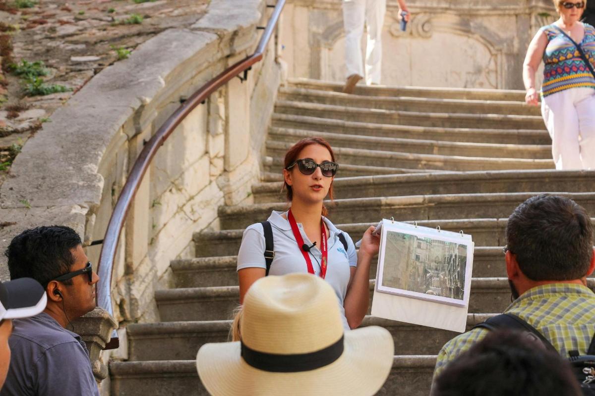 a woman standing on the stairs holding a map