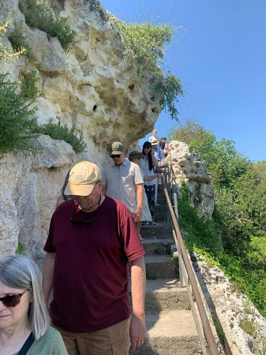 a group of people walking up a mountain