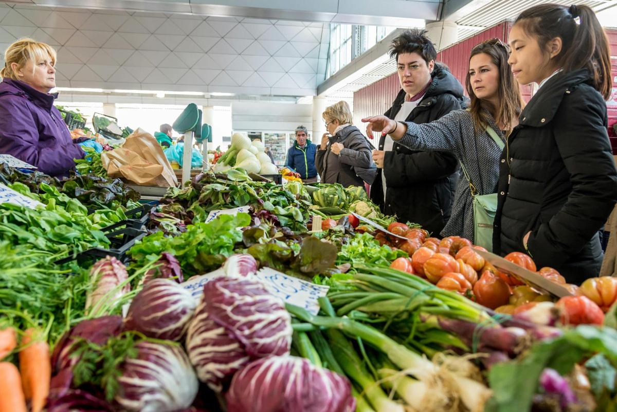 skupina lidí stojících na trhu se zeleninou