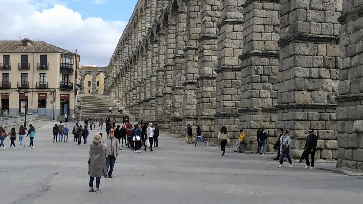 a group of people walking around a large building