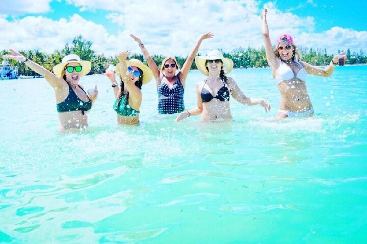 a group of women in the water on a beach