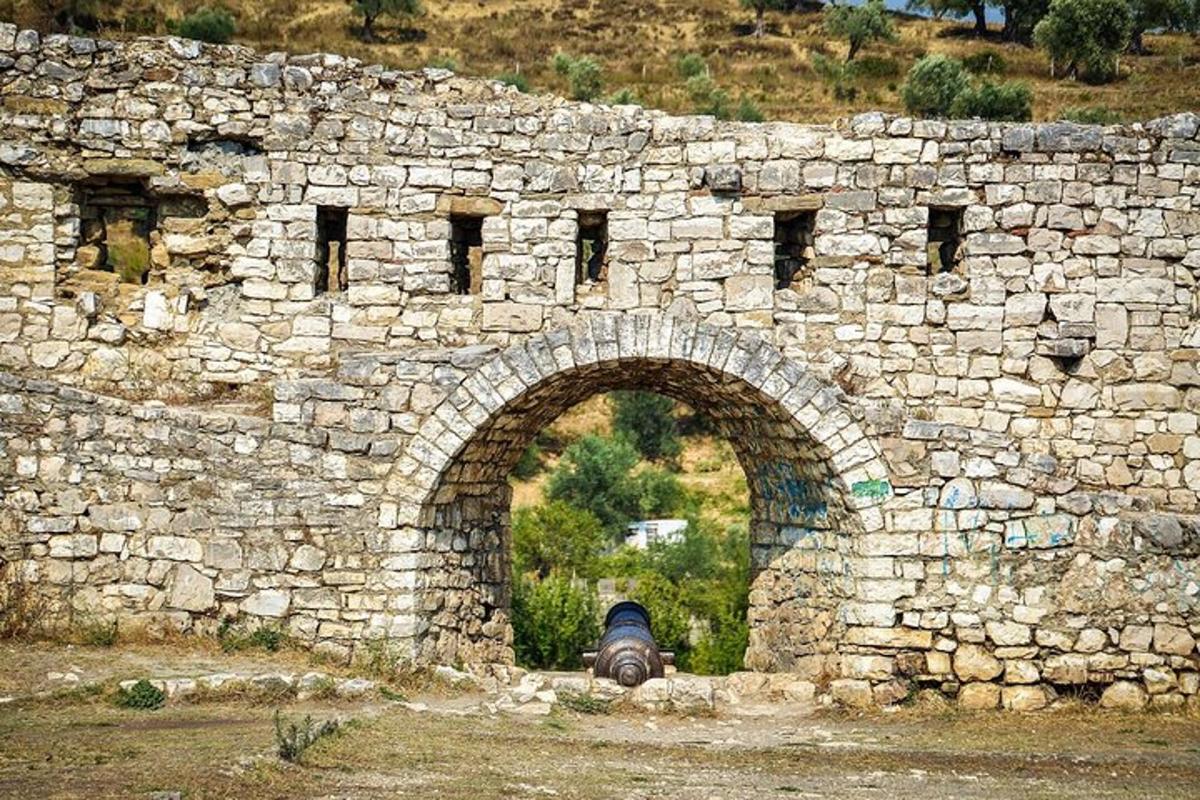 a stone wall with a car parked under it