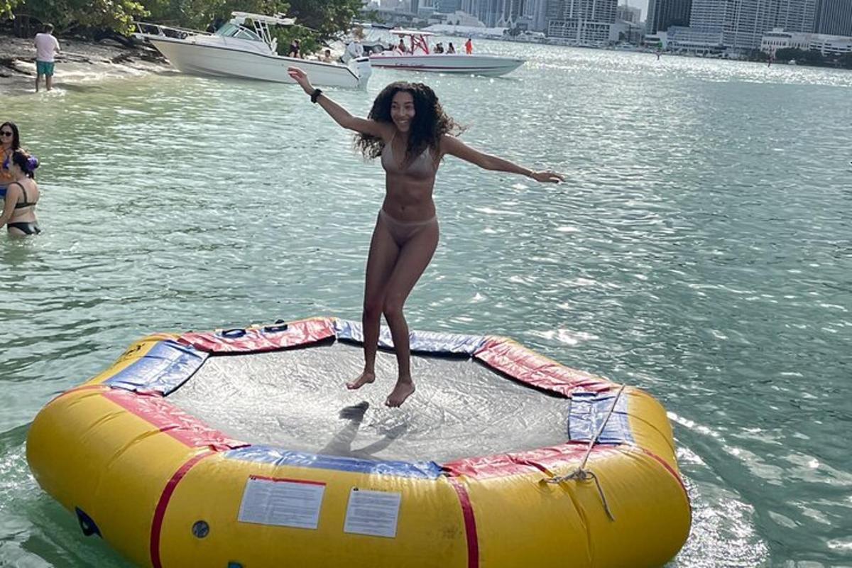 a woman jumping off the end of a raft in the water