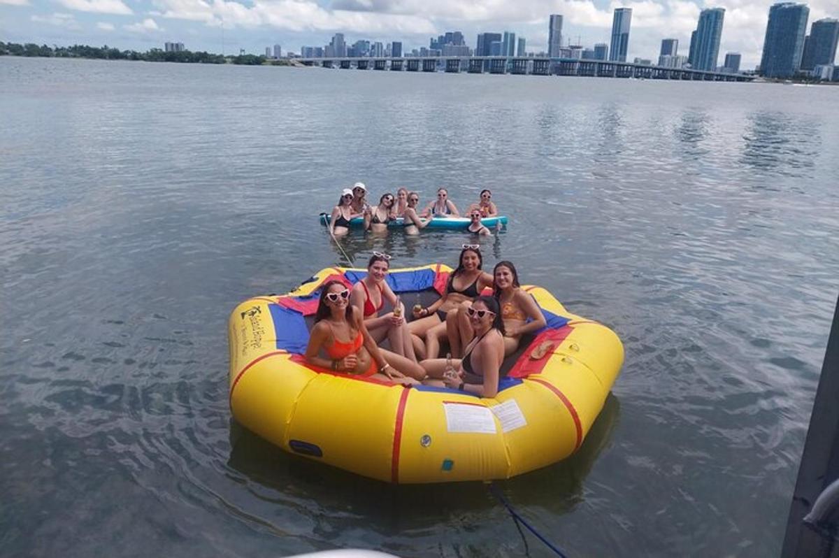 a group of people sitting on a raft in the water
