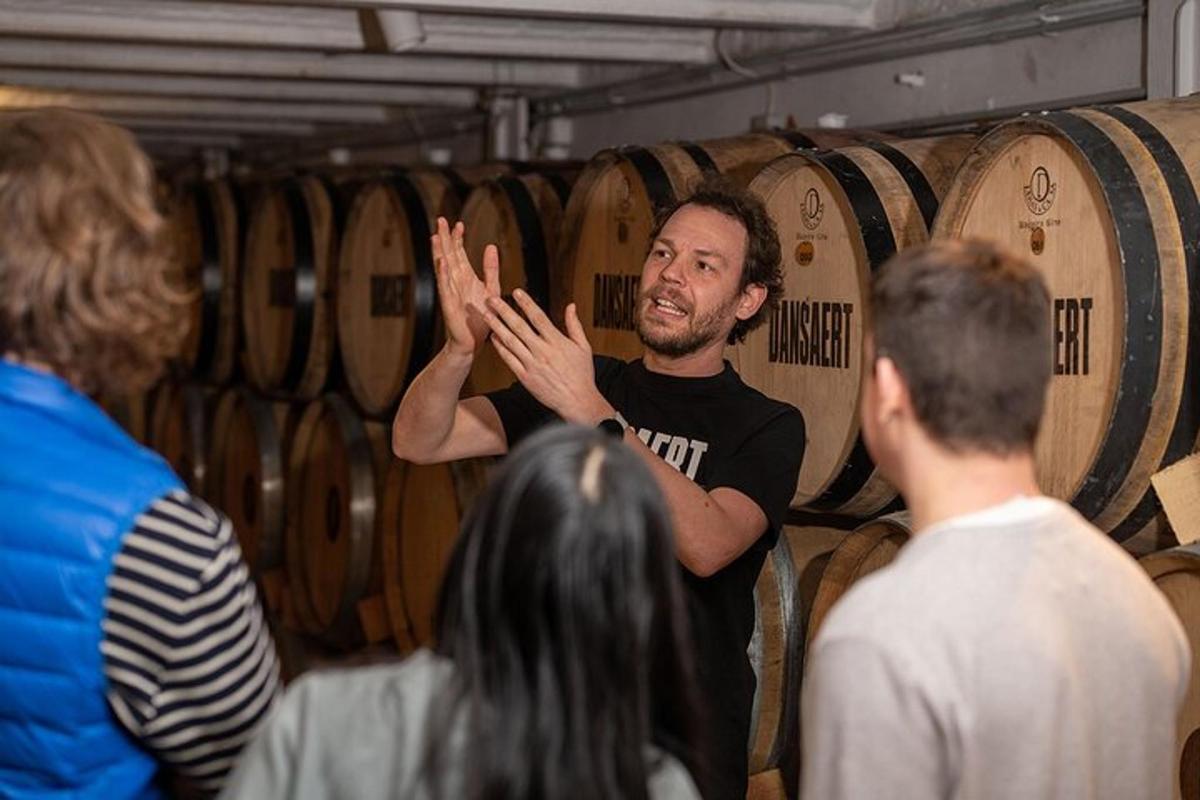 a man talking to a group of people in a wine cellar