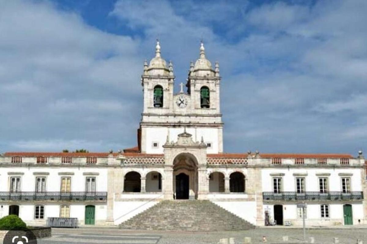 a large white building with a clock tower