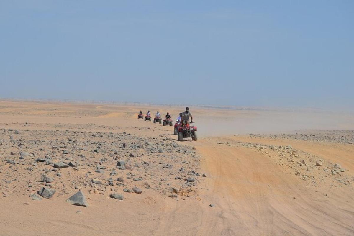 a group of people riding motorcycles on a dirt road