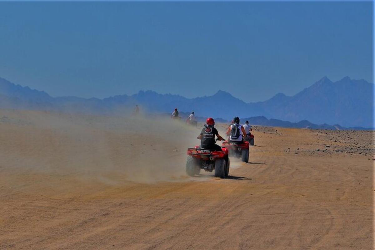 a group of people riding motorcycles on a dirt road