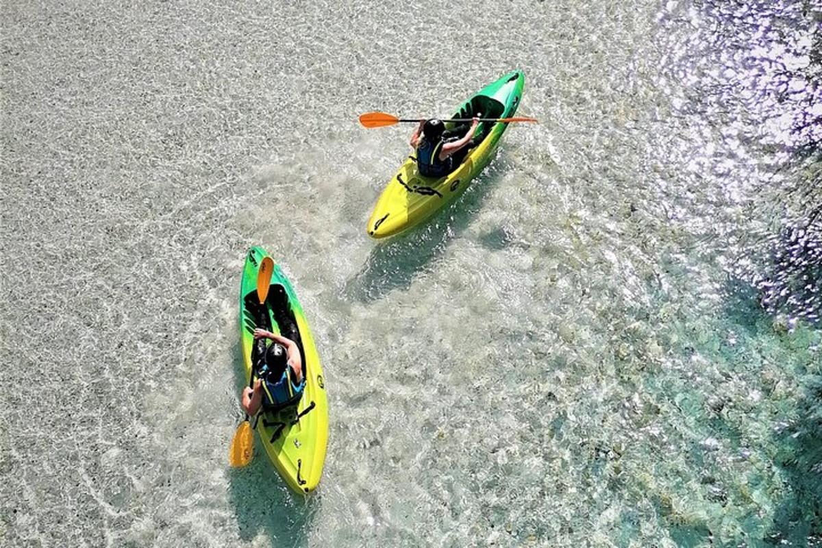 two people in yellow kayaks in the water