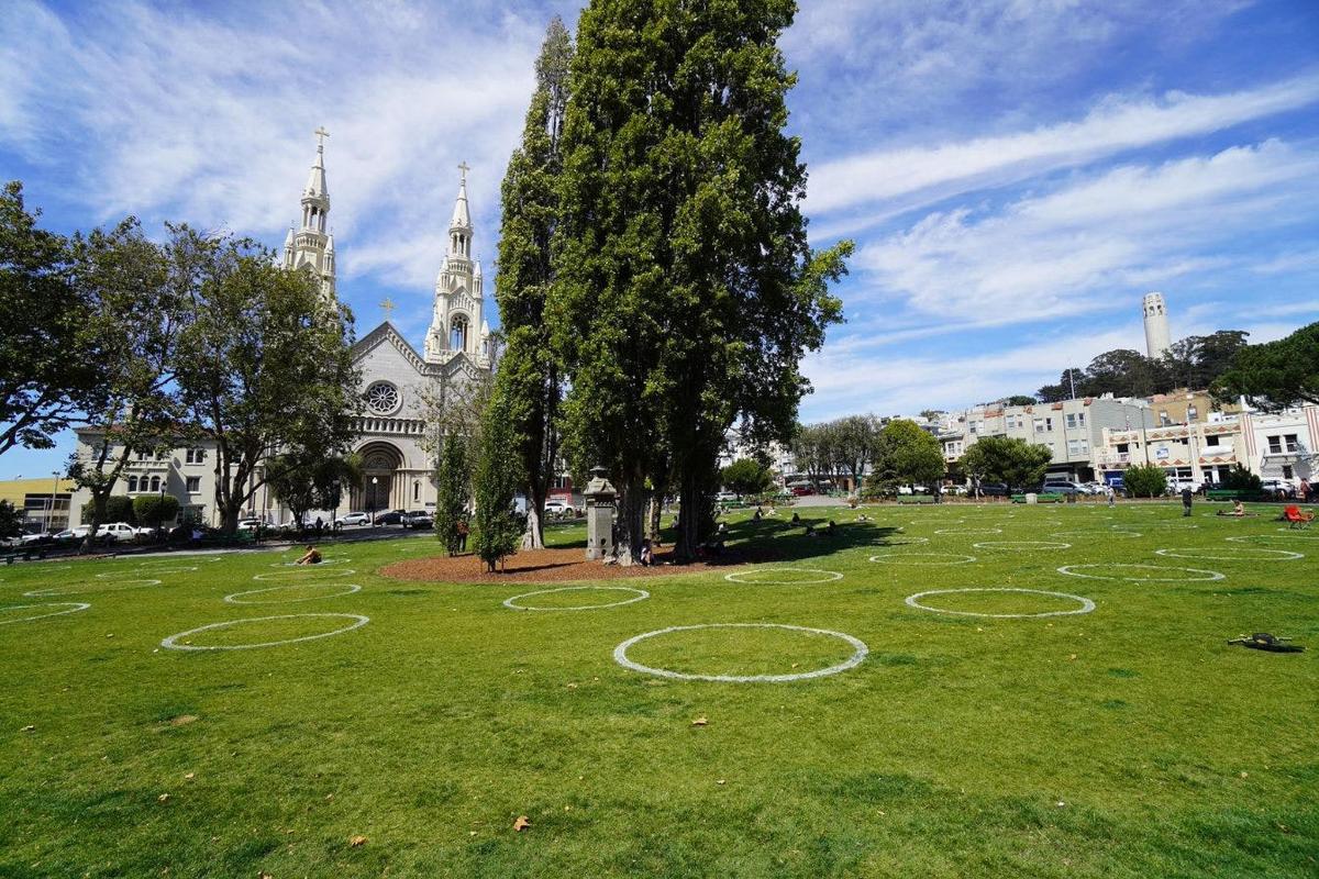 a large field with circles in the grass in front of a church