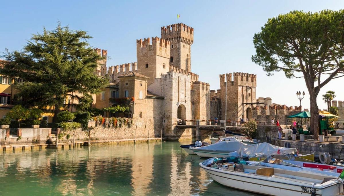 a castle with several boats in the water