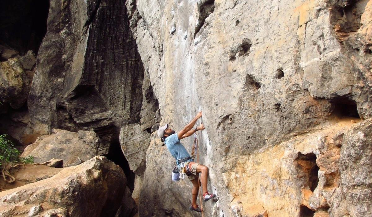 a man is climbing on a rock wall