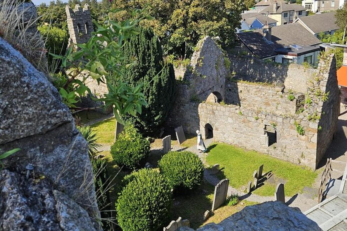 an aerial view of an old stone building with a cemetery