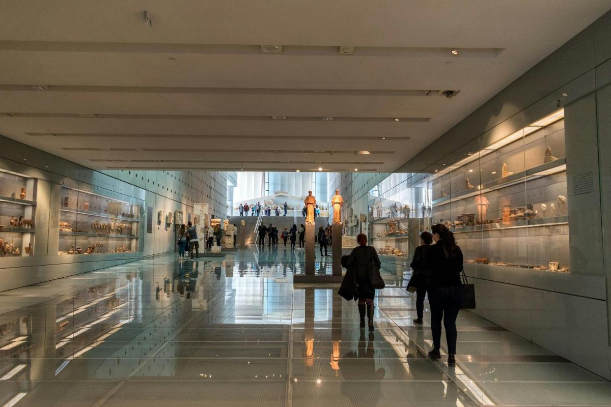 a group of people walking through a shopping mall