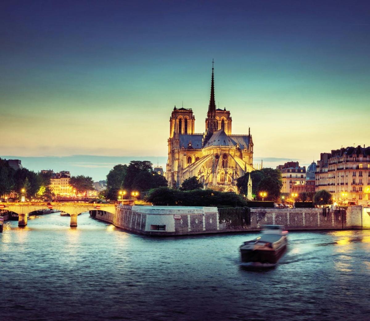 a boat on the river in front of a cathedral