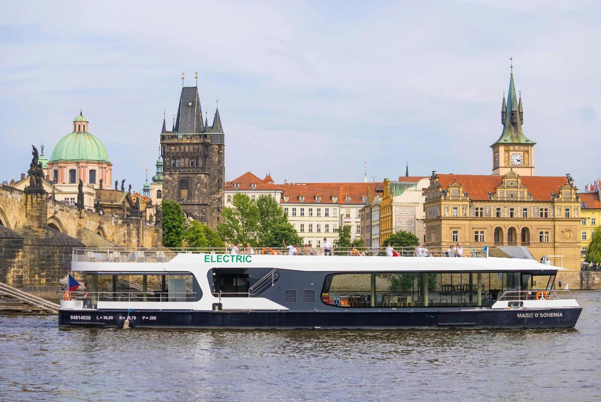 a boat in the water in front of a city
