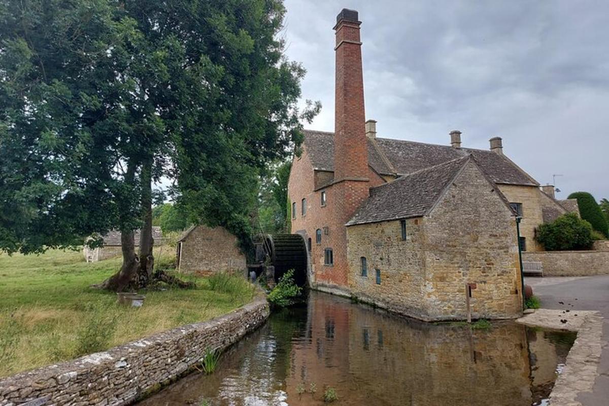 un vecchio edificio in pietra con un canale di fronte