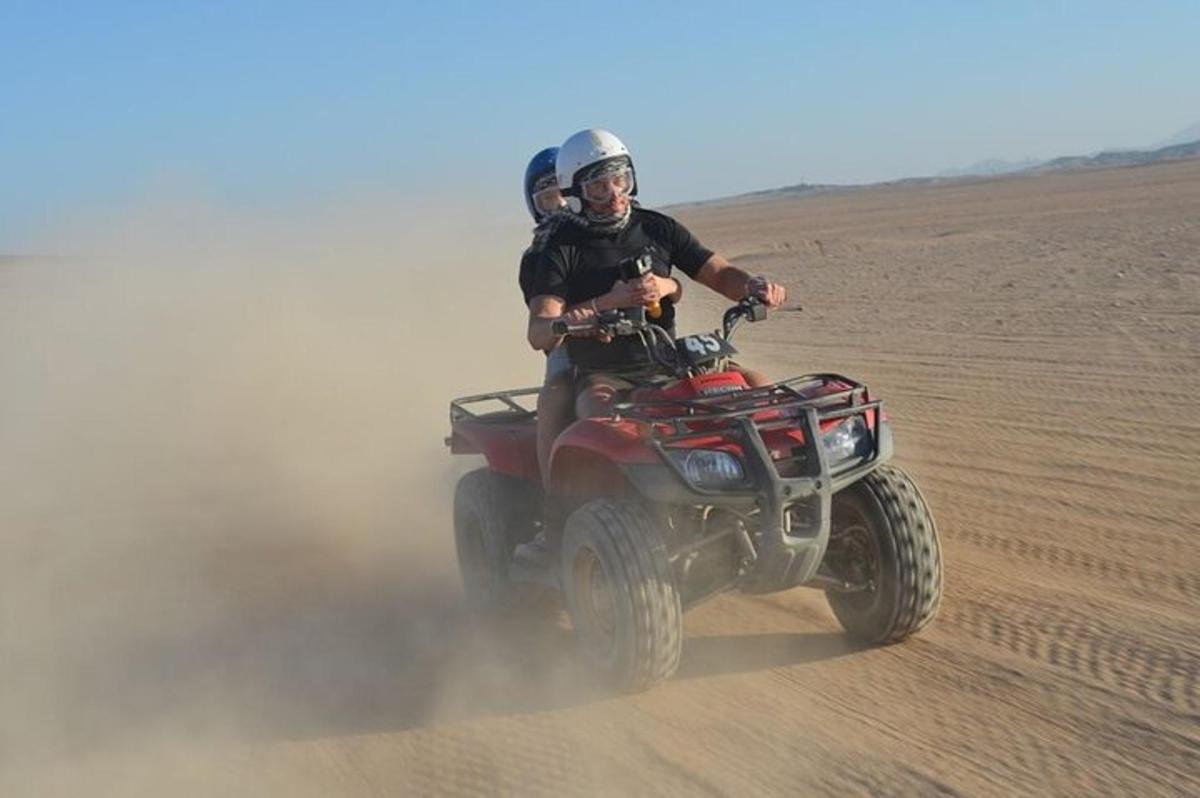 un home muntant un quad al desert