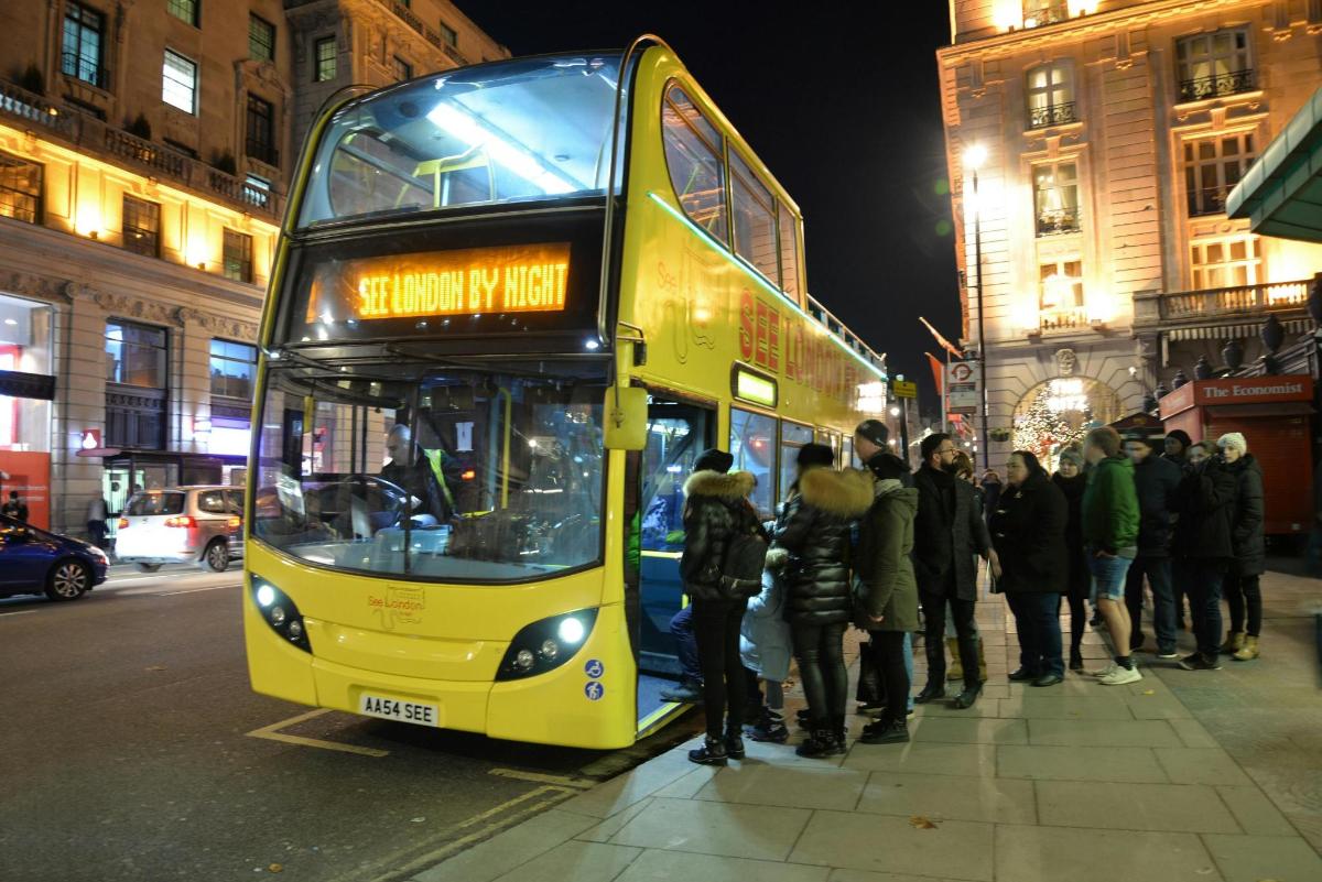 a yellow double decker bus parked on the side of the street