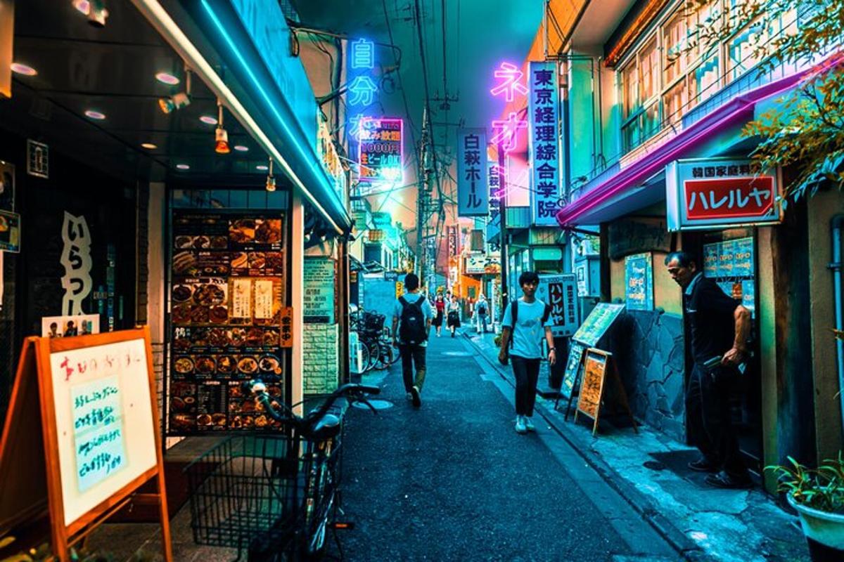 a city street at night with people walking down the street