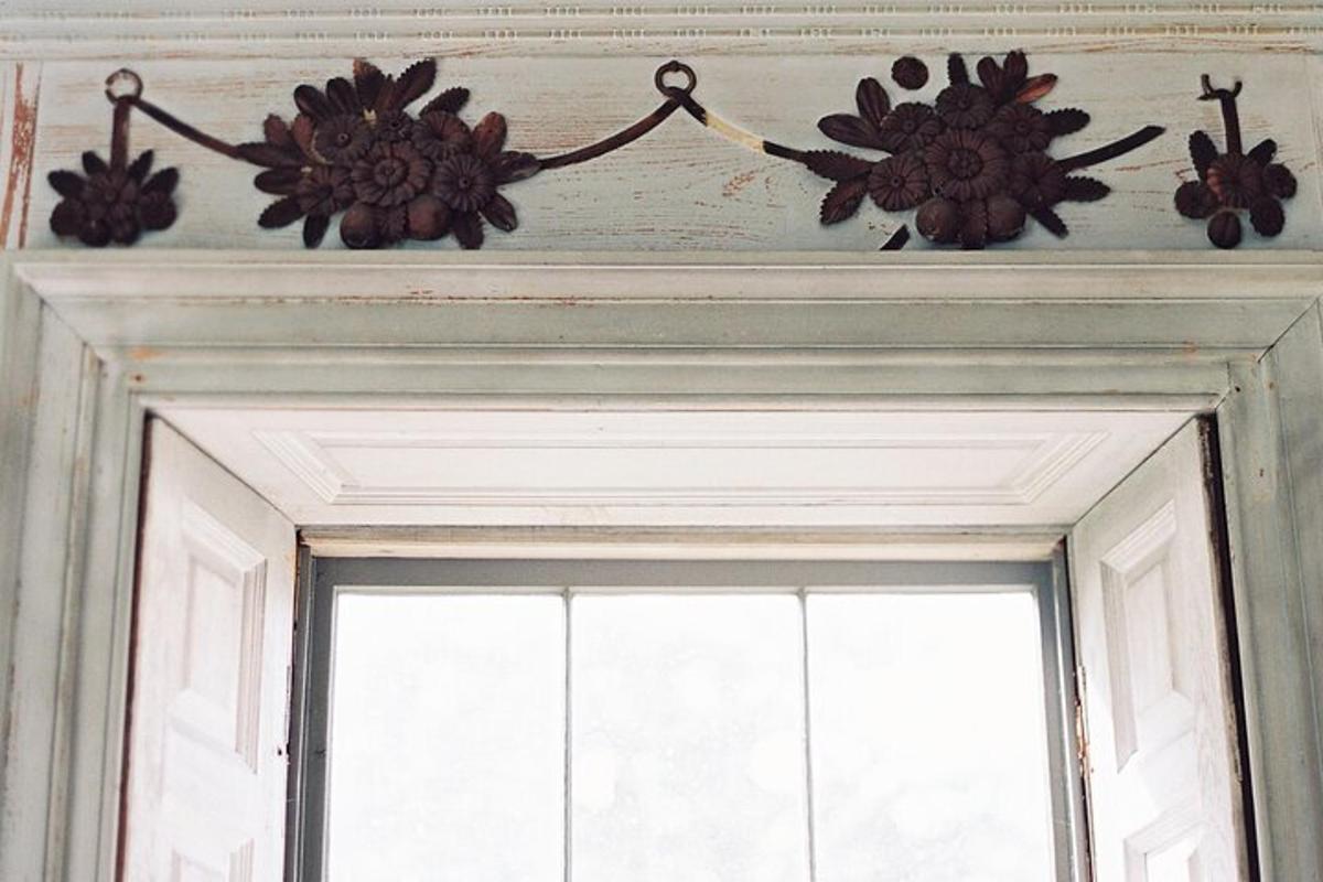 a chandelier hanging over a door with a window