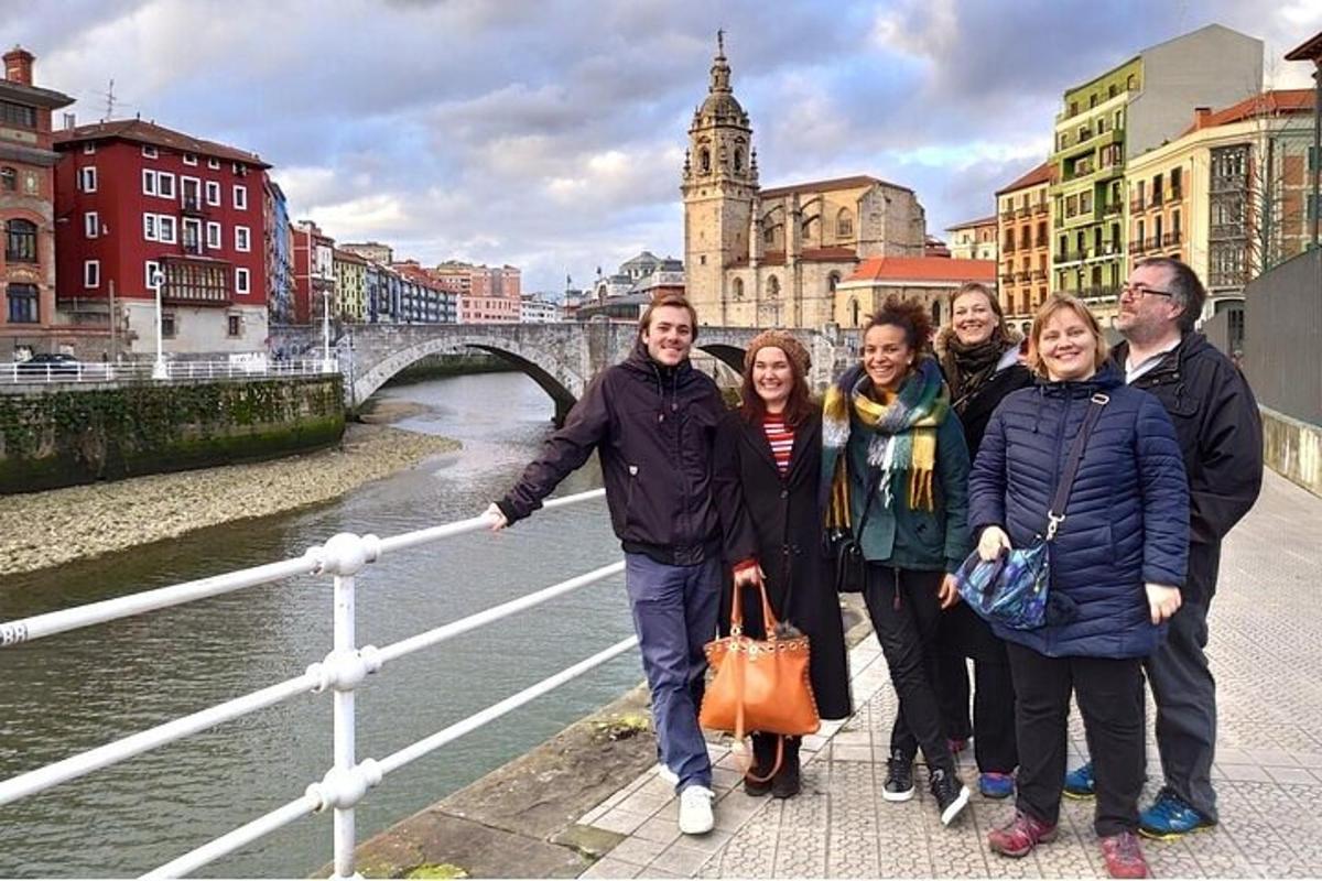 a group of people standing in front of a bridge