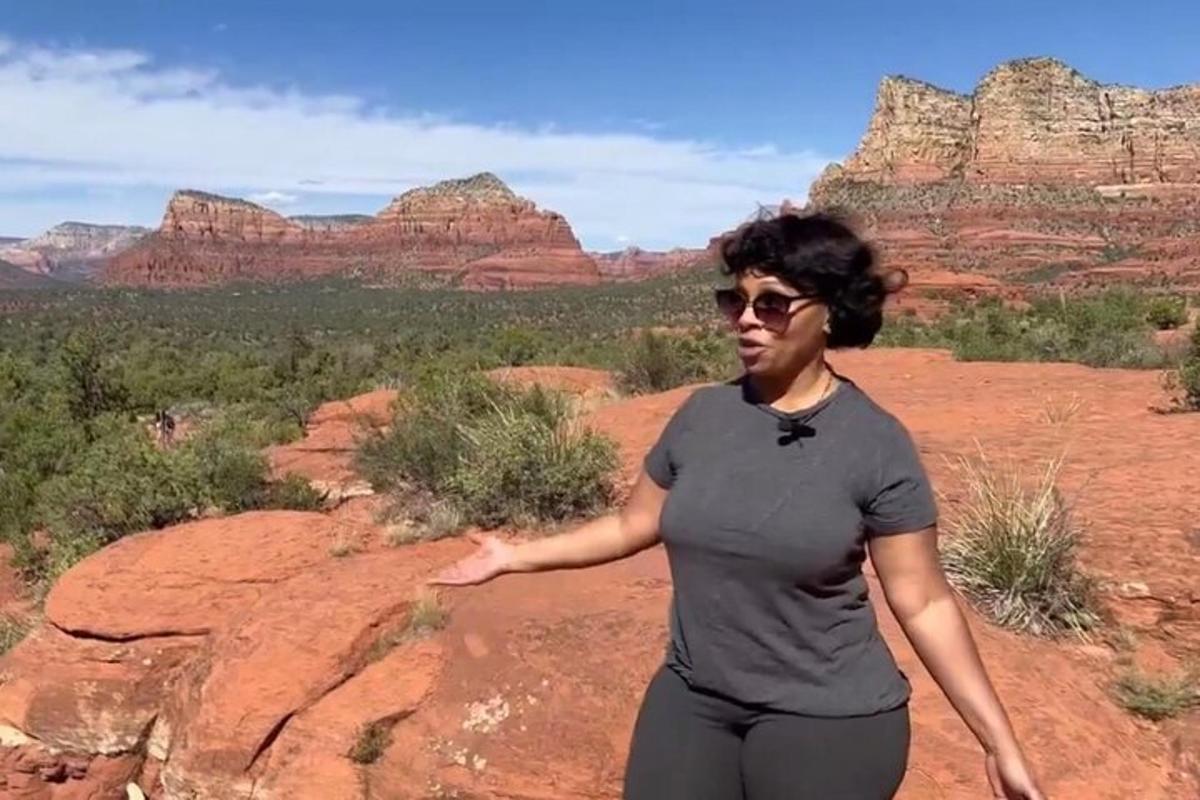 a woman standing on a rock in the desert