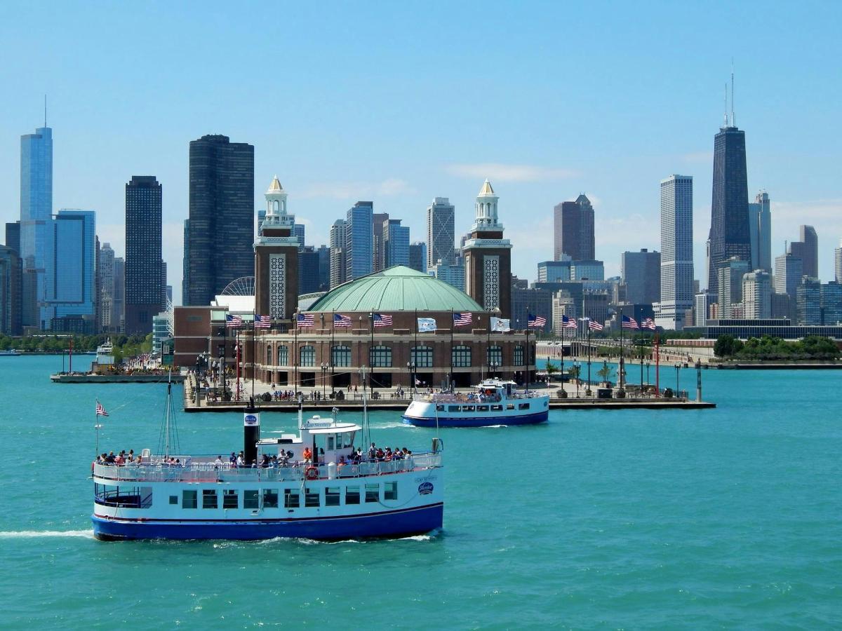two boats in the water in front of a city
