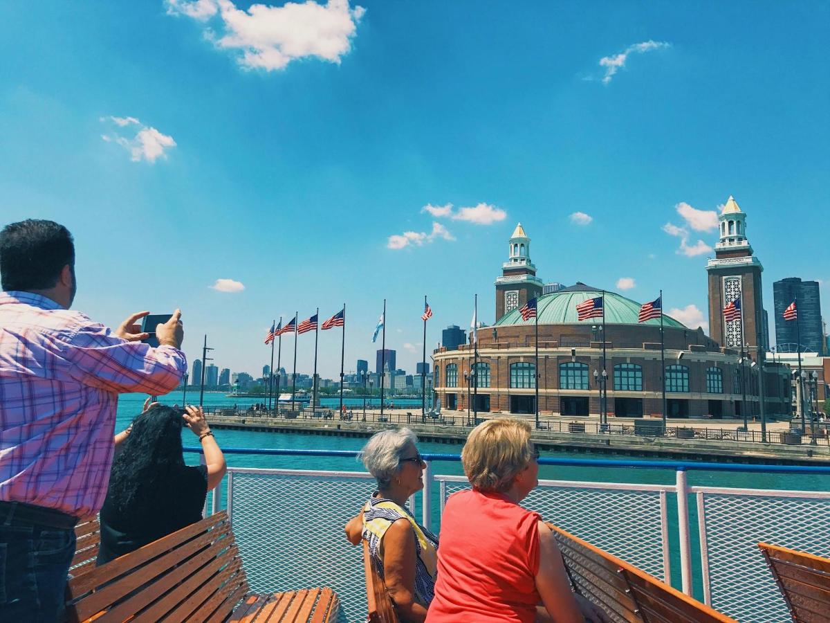 a man taking a picture of people sitting on a ferry