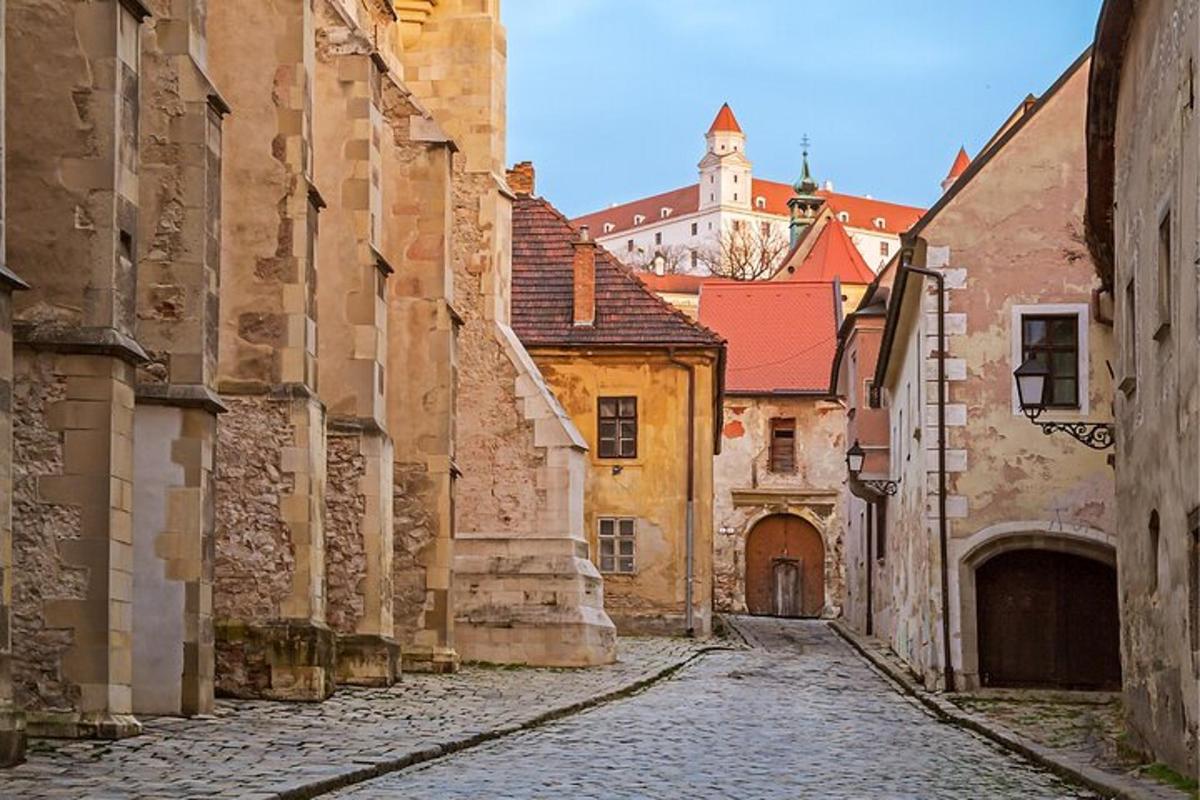 an alley in an old town with a clock tower