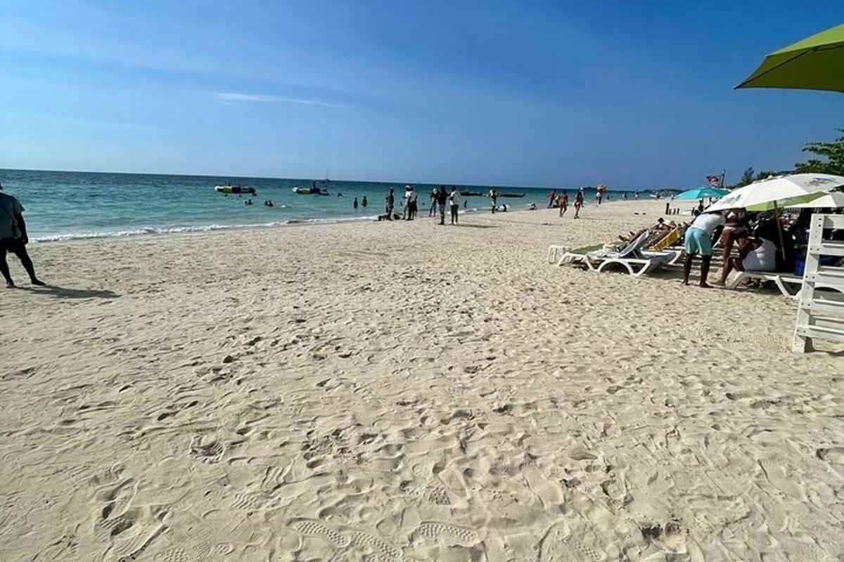 a group of people on a beach with umbrellas