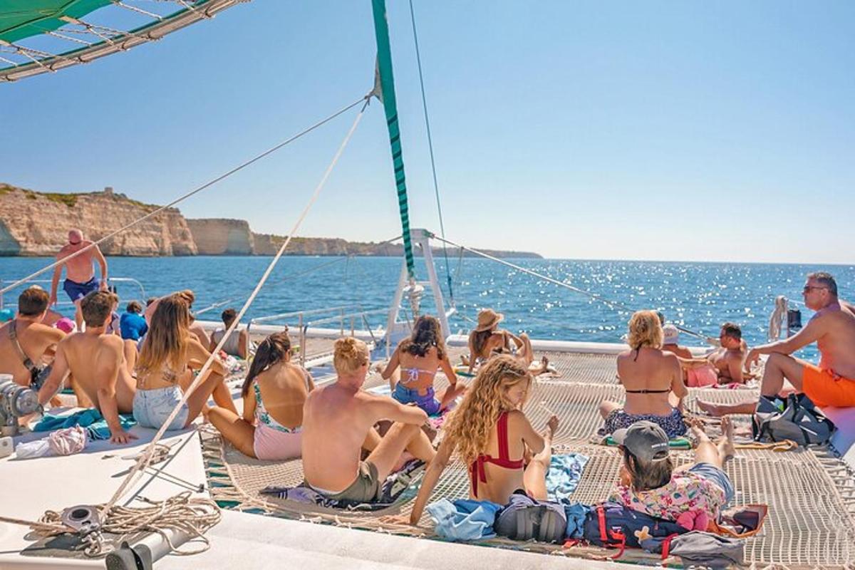 a group of people sitting on the deck of a boat