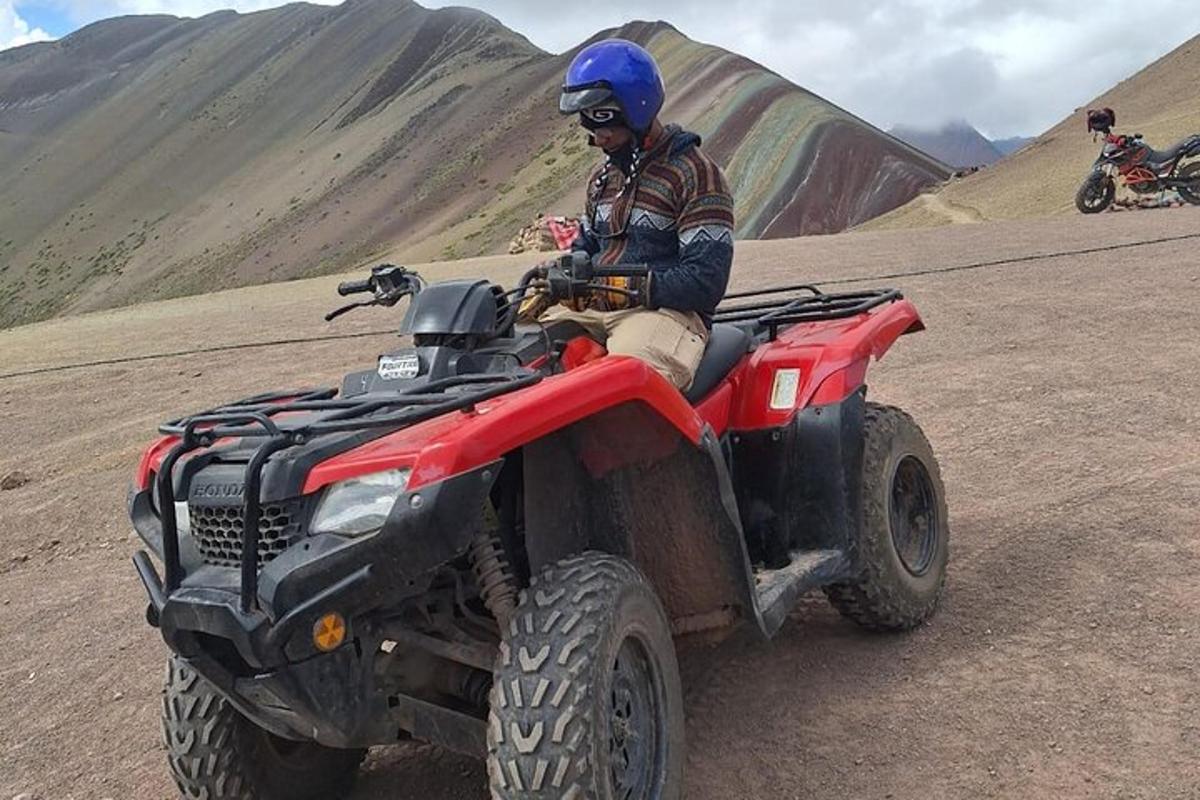 un home que condueix un quad al desert
