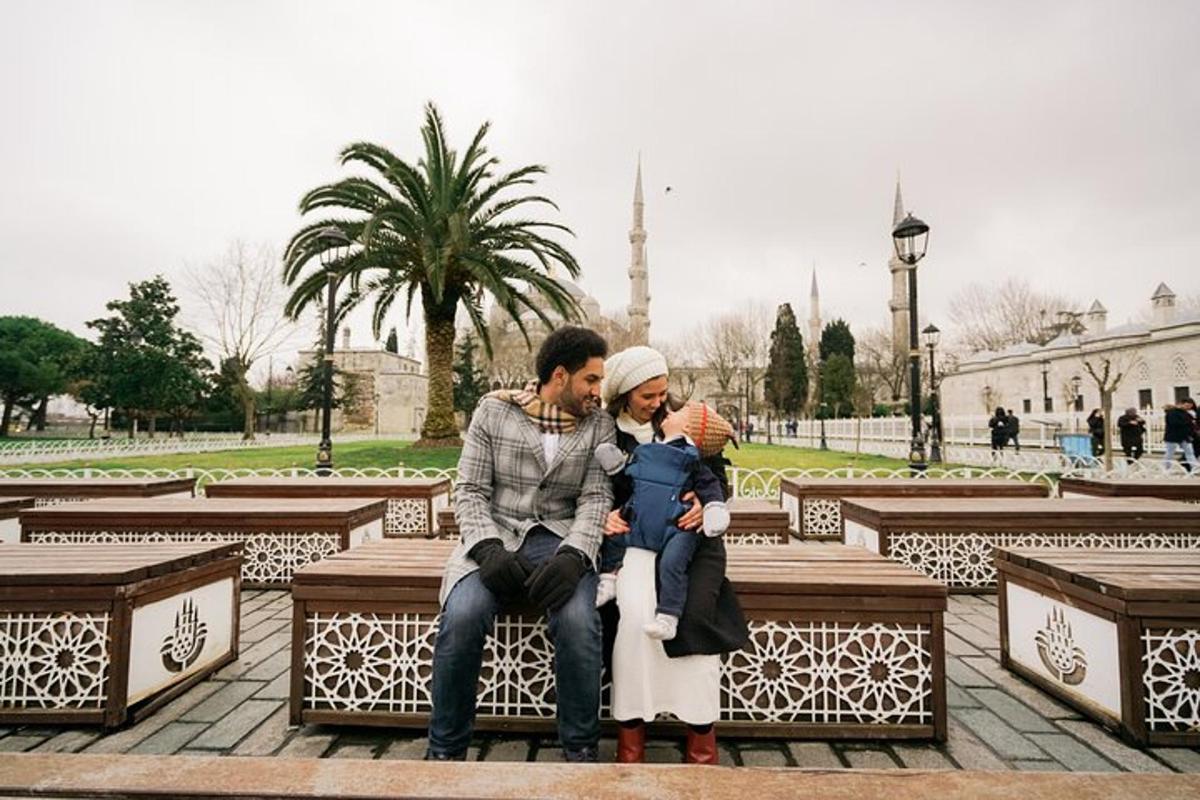 a man and a woman and a child sitting on a bench