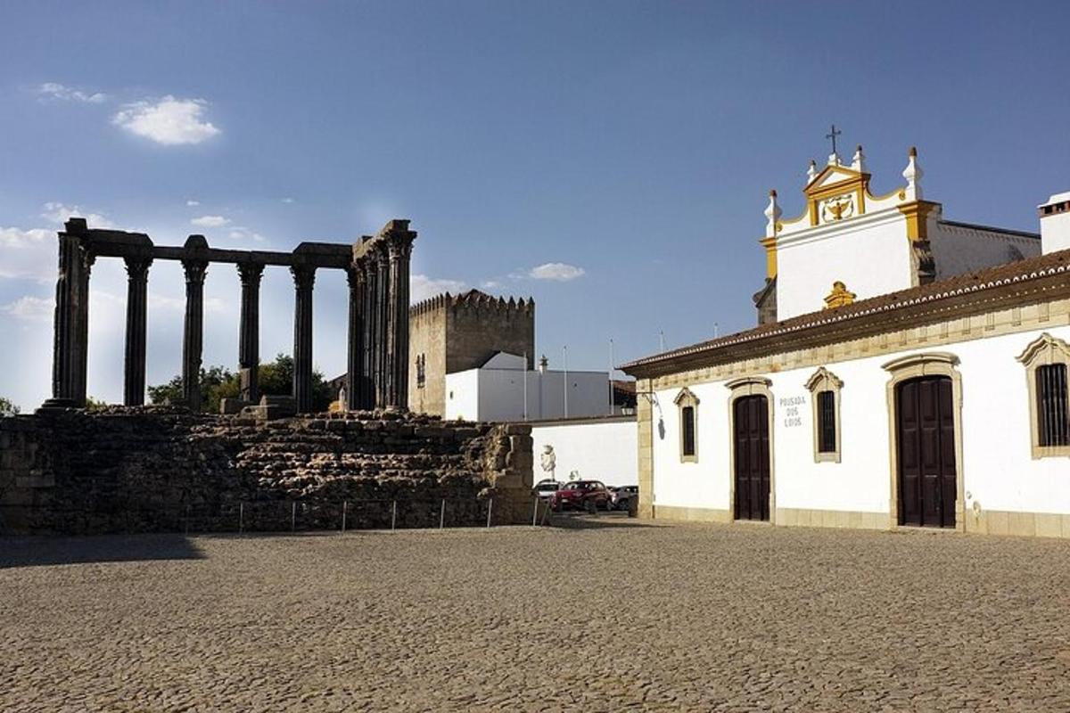 un vecchio edificio con colonne di fronte a una chiesa