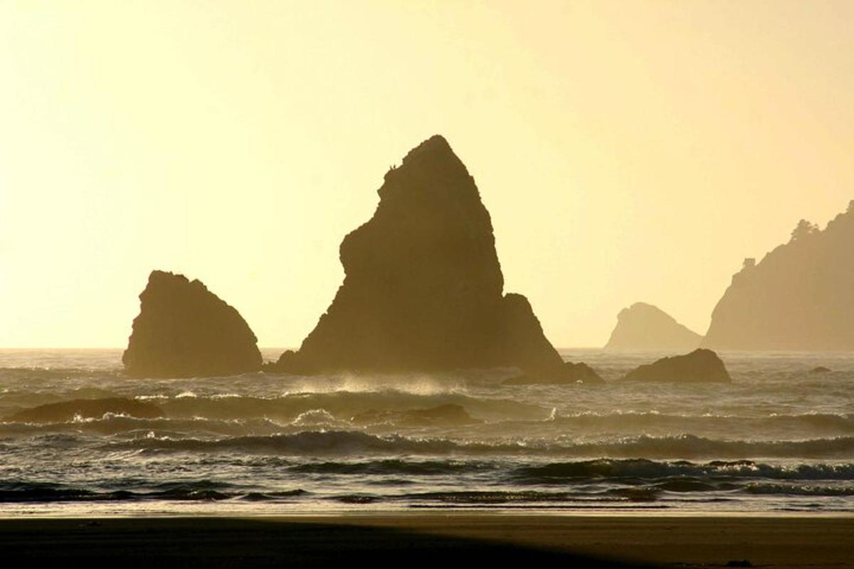 a group of large rocks in the ocean