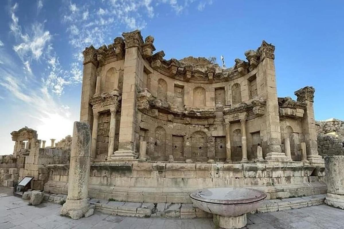 a large stone building with a fountain in front of it