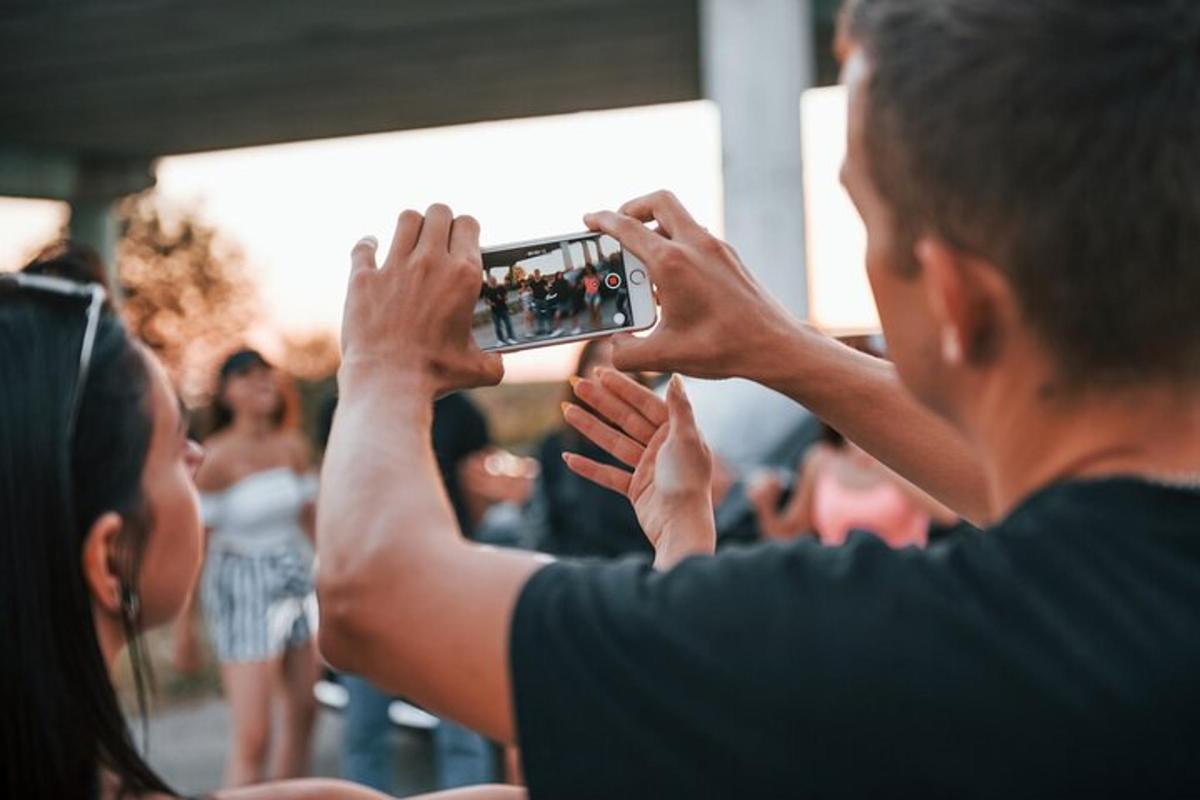 a person taking a picture with a cell phone