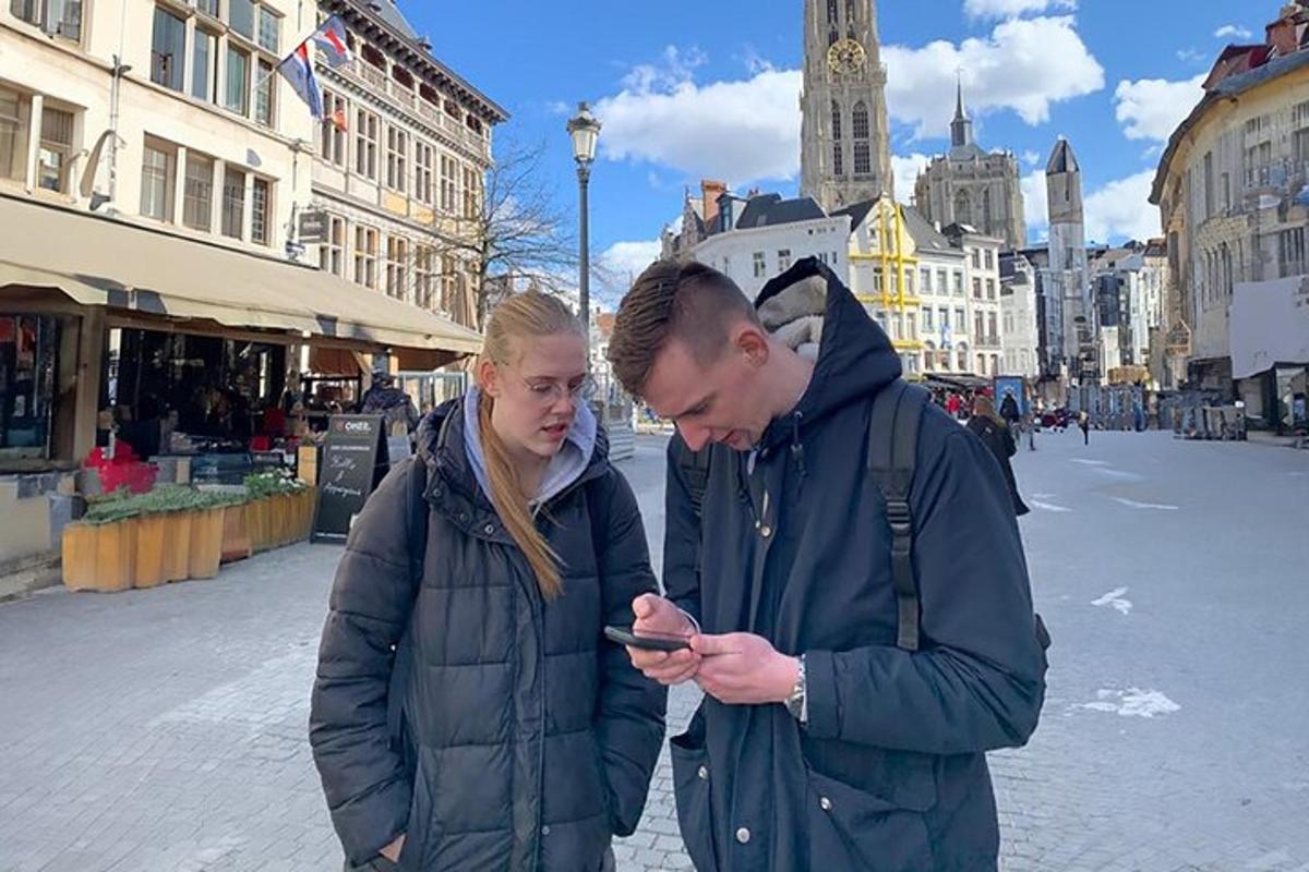 a man and a woman looking at a cell phone