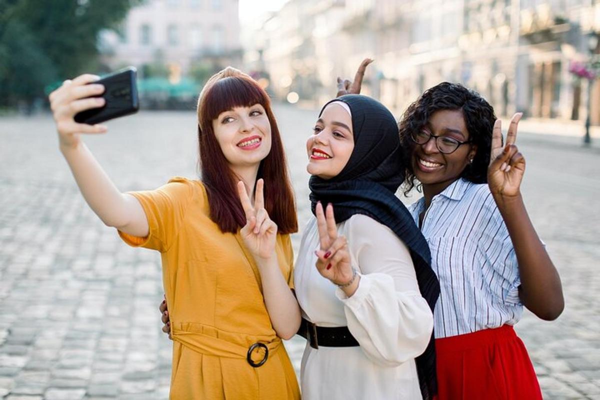three people posing for a picture with their hands up