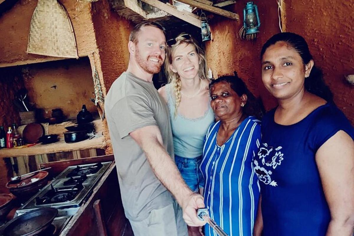 a group of people posing for a picture in a kitchen
