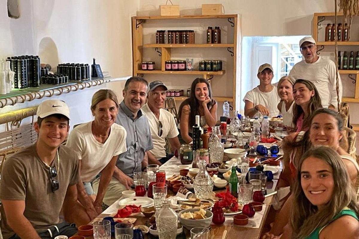 un grup de persones assegudes al voltant d'una llarga taula