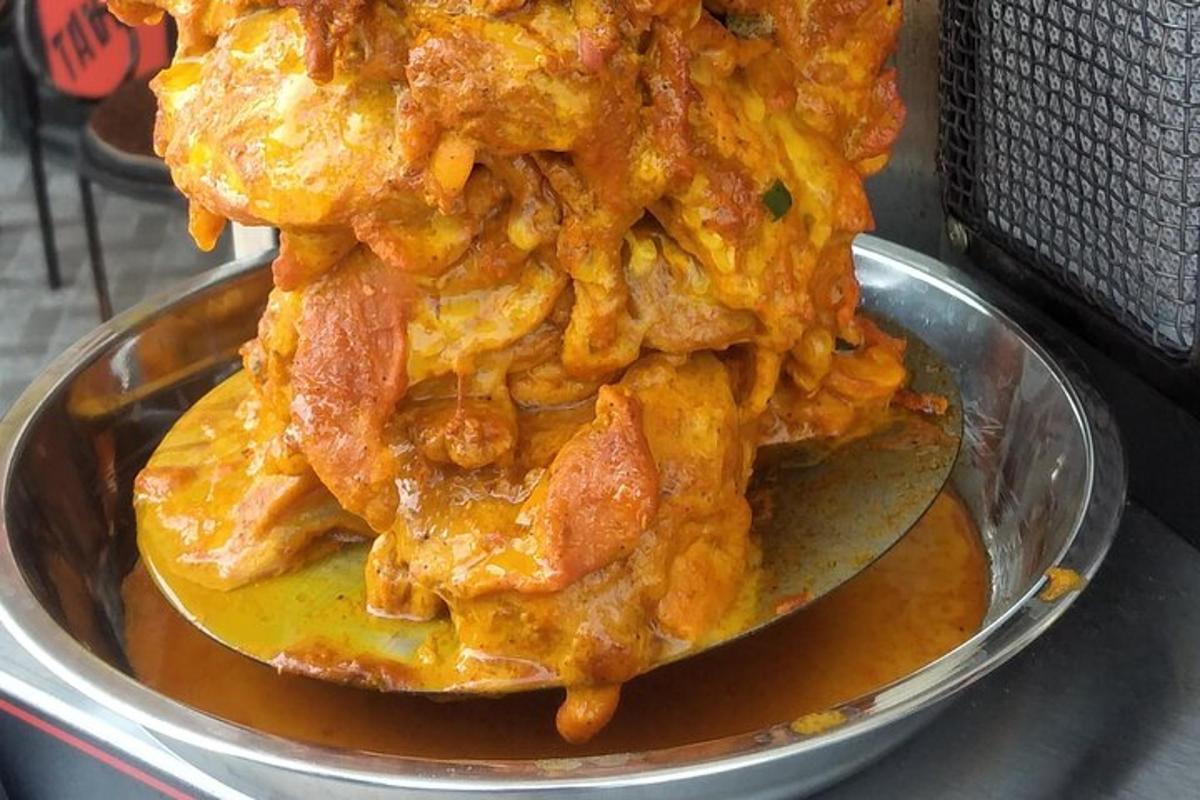 a pile of food on a spoon in a metal bowl