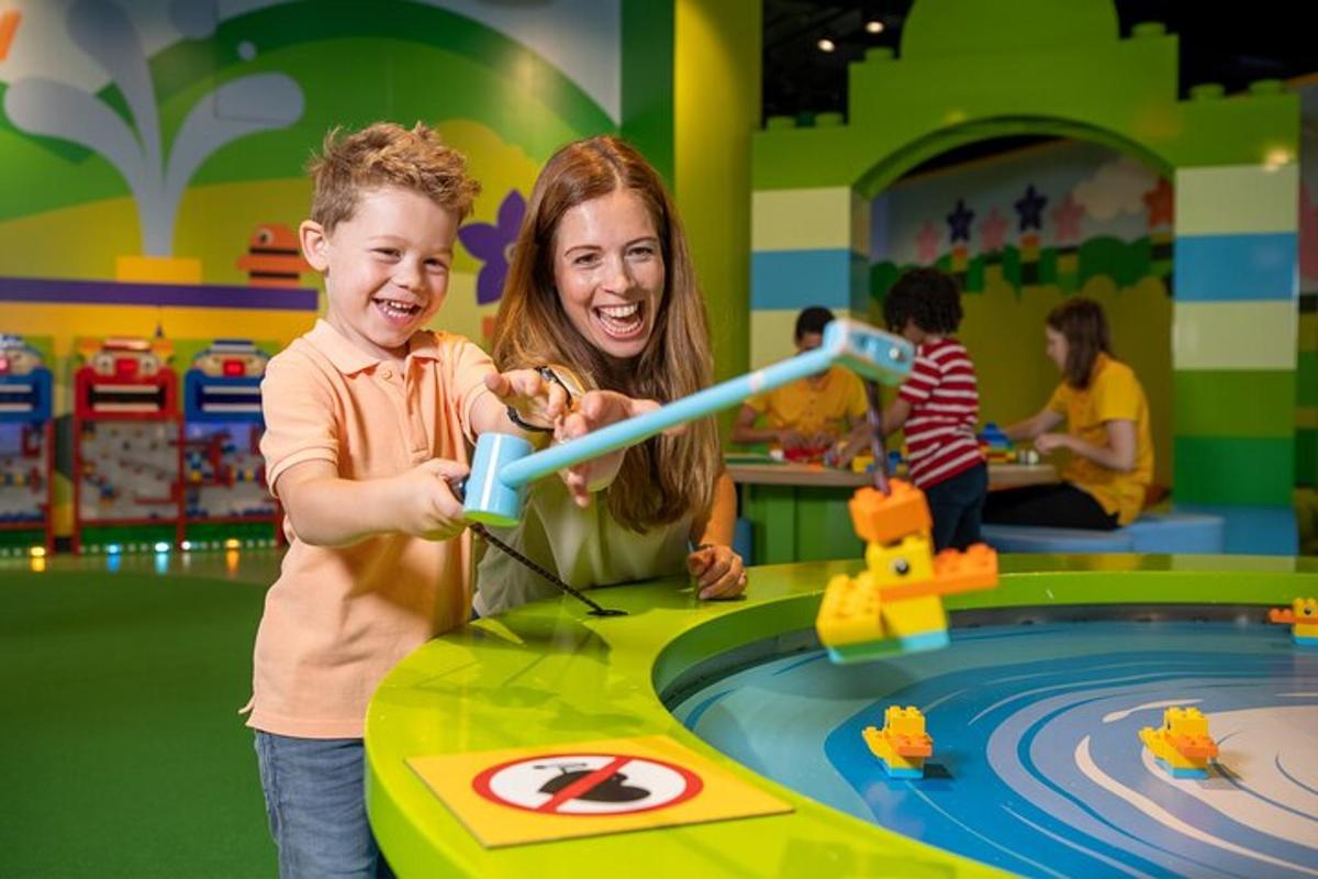 a woman and a child playing with a toy in a playground