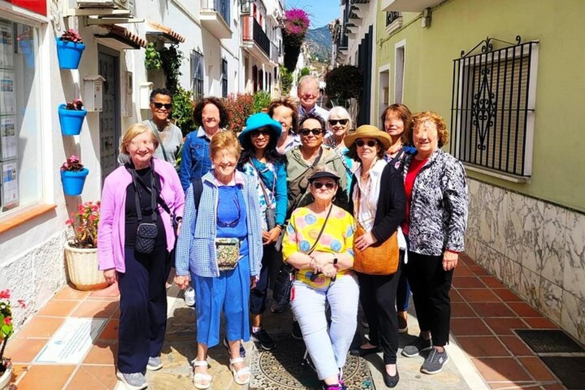 a group of people posing for a picture on a street